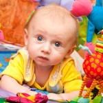 Baby plays in development gym