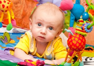 Baby plays in development gym